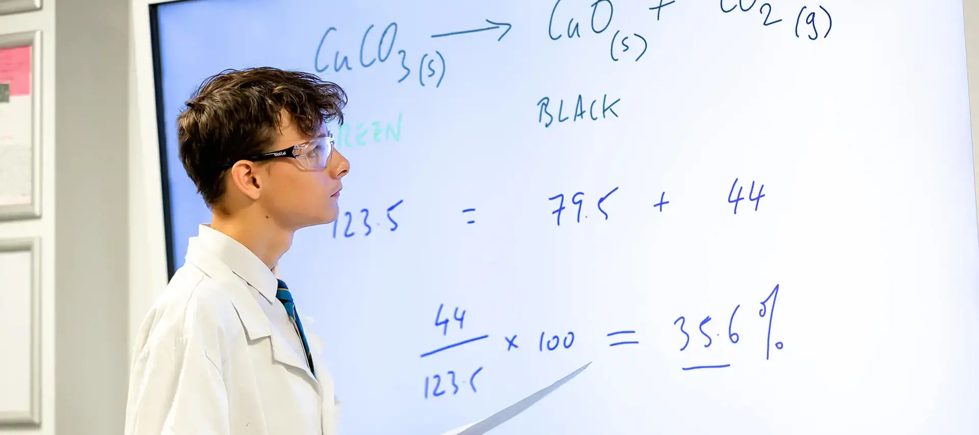 A student at The Gregg School looking at equations on a digital whiteboard