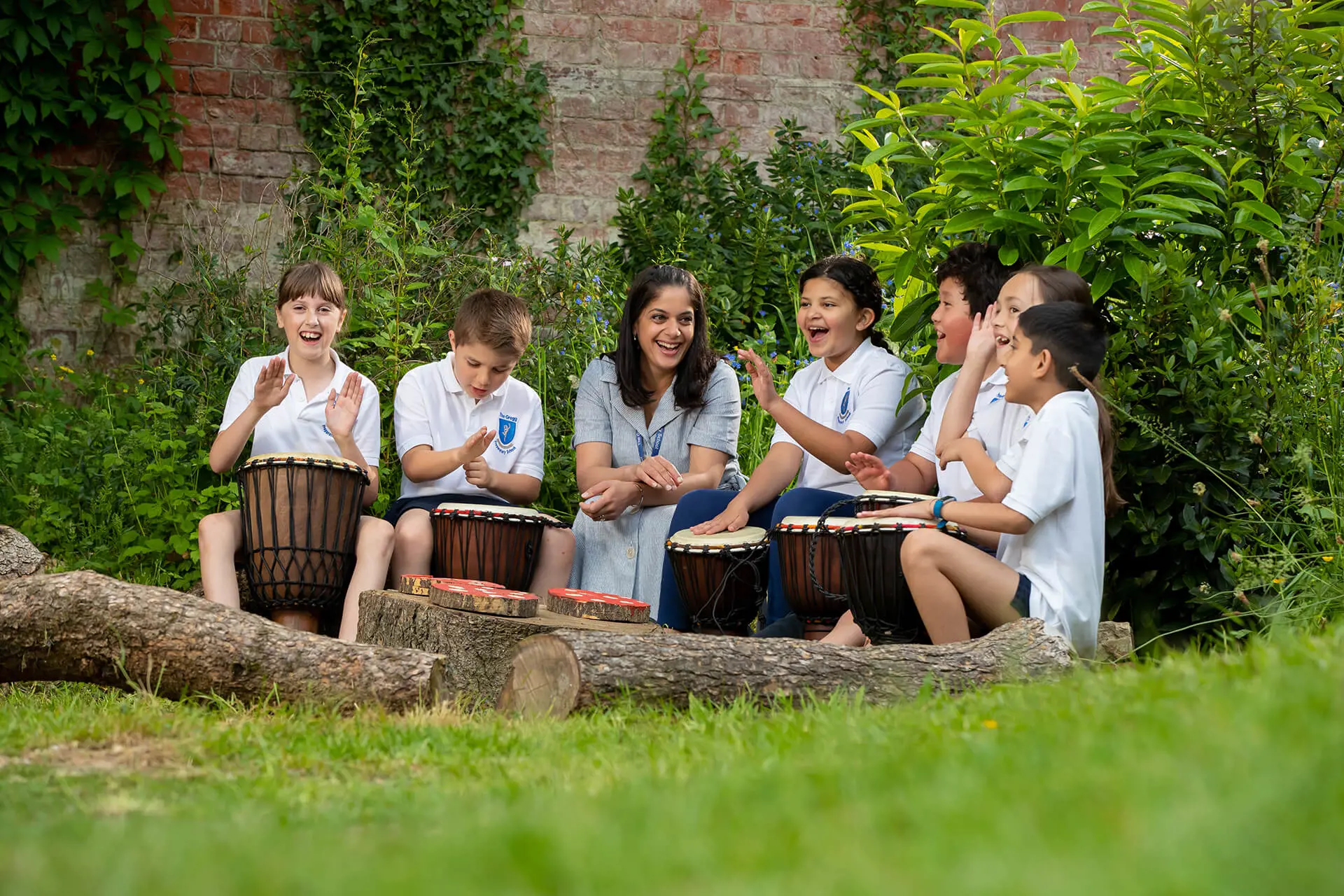 Students and teacher playing music outside at The Gregg Prep School