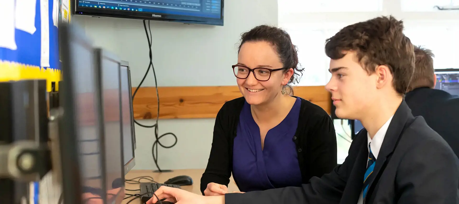 Student and teacher working together in the computer lab at The Gregg School